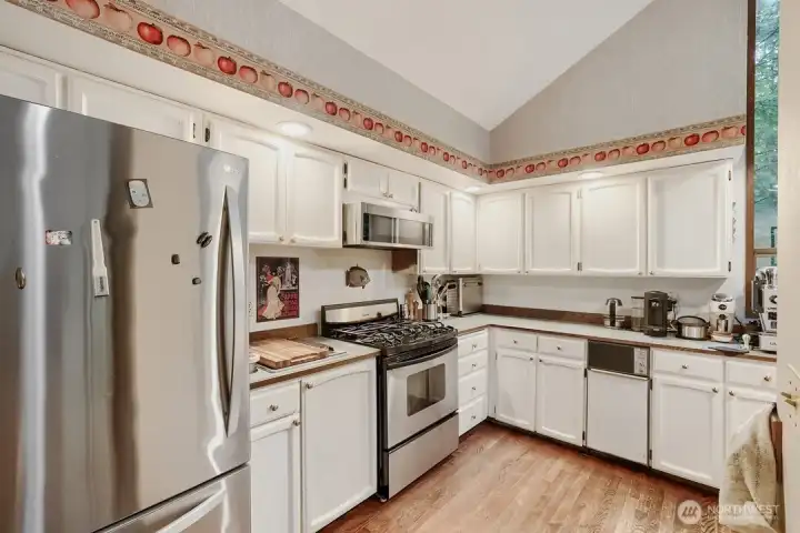 The kitchen's vaulted ceiling creates a space that feels both spacious and inviting. The kitchen's vaulted ceiling creates a space that feels both spacious and inviting.