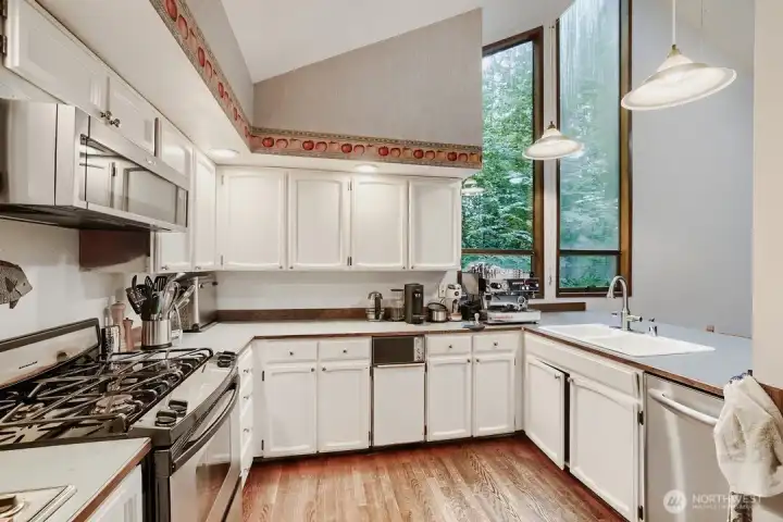 Stainless appliances, including a gas cooktop, complement this kitchen. Stainless appliances, including a gas cooktop, complement this kitchen.