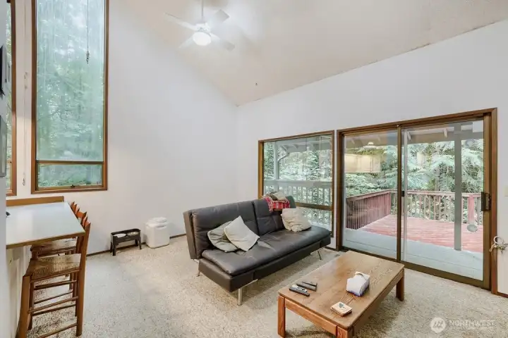 The family room area off the kitchen with a slider that opens to the deck for seamless indoor-outdoor living. The family room area off the kitchen with a slider that opens to the deck for seamless indoor-outdoor living.