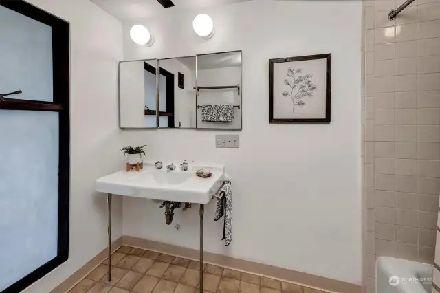 The bathroom downstairs has a charming pedestal sink and bathtub.