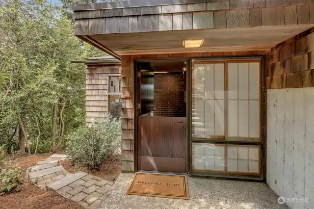 The charming Dutch front door and shoji screens add to the intrigue.