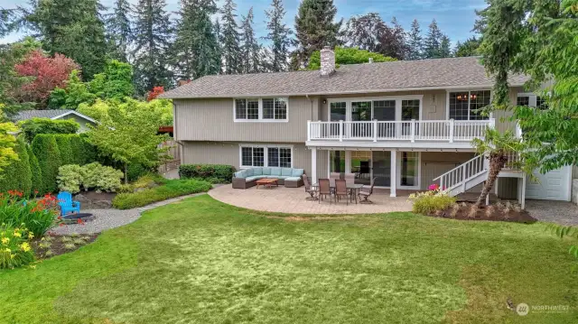 Drone view of the back yard with the fire pit showcasing all that this home has to offer.