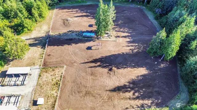 Horse-side of the 21 acres, two fenced pastures, 5 stalls with paddocks, shelters in the pasture areas. Metal pole building / barn for hay storage, not in this photo.