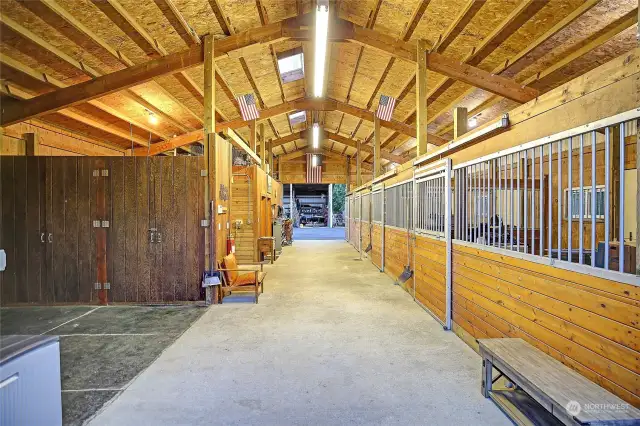 The modern, clean barn features 4 stalls, a wash rack, and a tackroom/ live-in suite with full bathroom