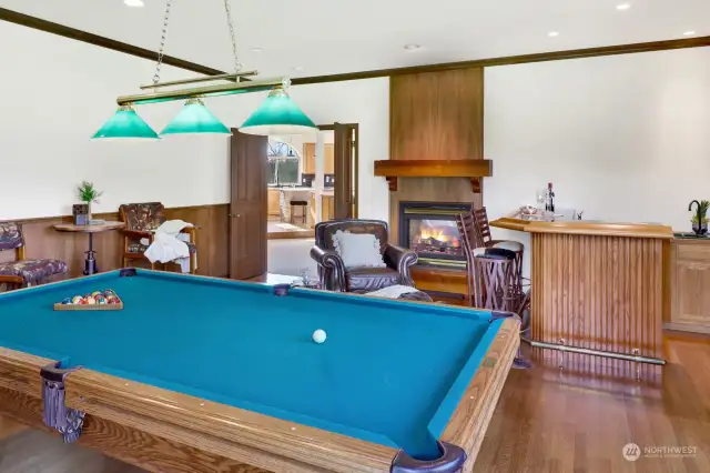 The games room has a wetbar and a double-sided fireplace