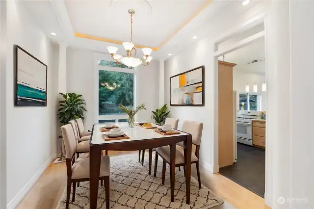 Virtually staged dining  with lit coffered ceiling