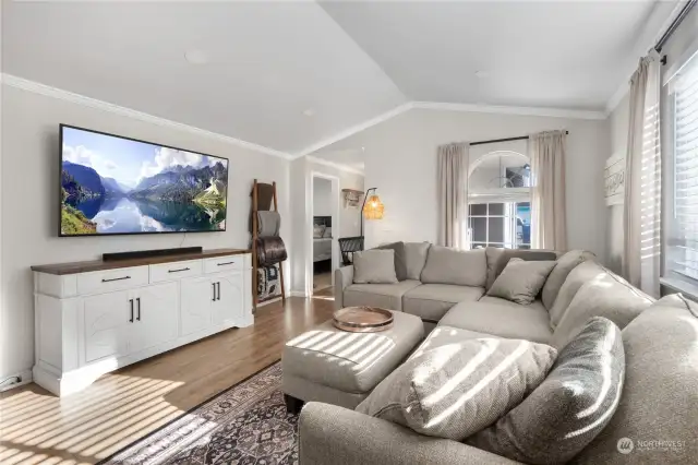 Large living room is flooded with natural light through 2 large windows. Plenty of room for whatever size TV desired.