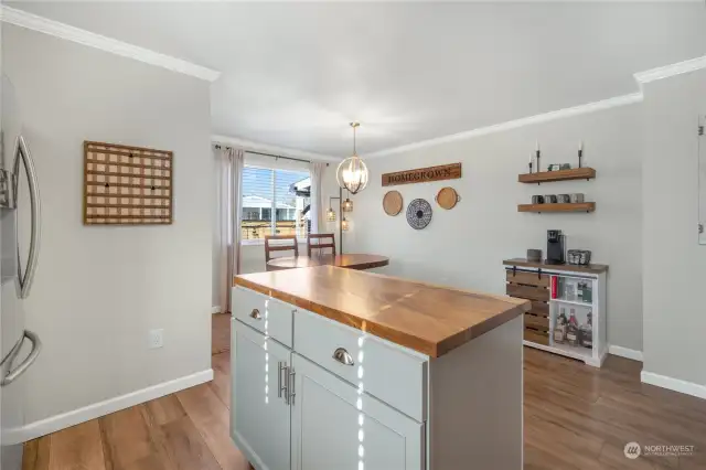 Dining  and large wall offering space for additional cabinetry, if desired, or additional furniture pieces.