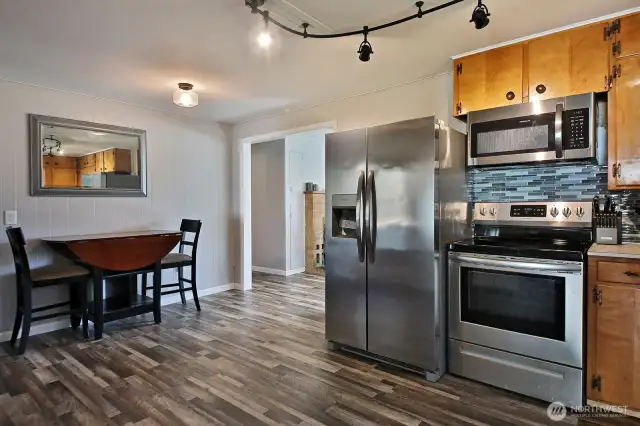 As you enter through the rear door closer to the parking area, the kitchen leads to the living room.