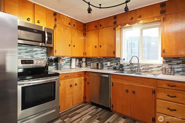 Stainless appliances and tile backsplash.