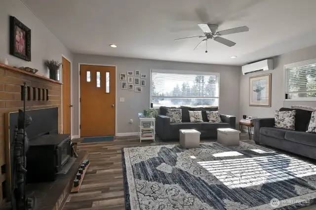 Spacious and light living room with airtight woodstove and ductless mini split.