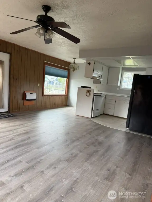 Living room view looking at dining room and kitchen