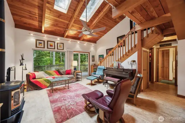 Open concept with vaulted wood ceilings, cooling fan.