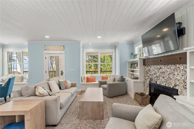 Main level living room with wood burning fireplace & built-ins