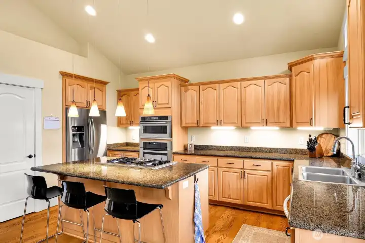 Granite counters, maple cabinets, large pantry, gas cooktop and built in oven.