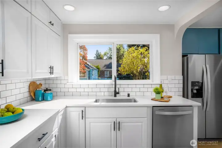 Quartz countertops and stainless steel appliances.