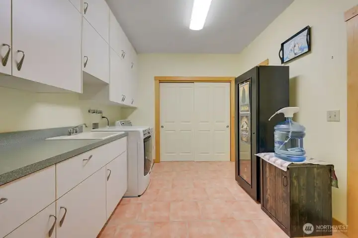 Large laundry room with extra storage.