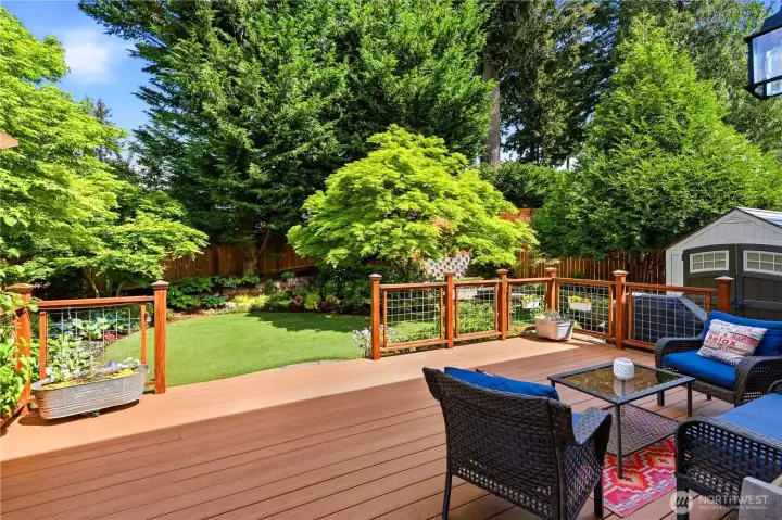 Private backyard deck with durable Azek decking, perfect for outdoor dining, entertaining, and enjoying the landscaped yard.