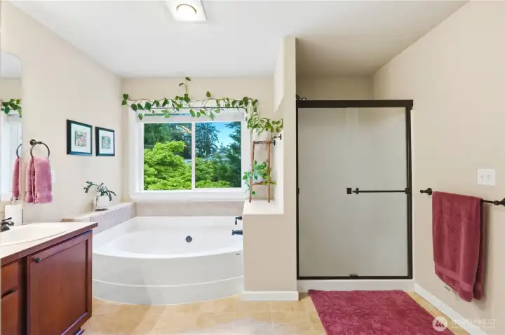 Primary bathroom with soaking tub, separate shower, and dual vanity—designed for comfort and functionality.