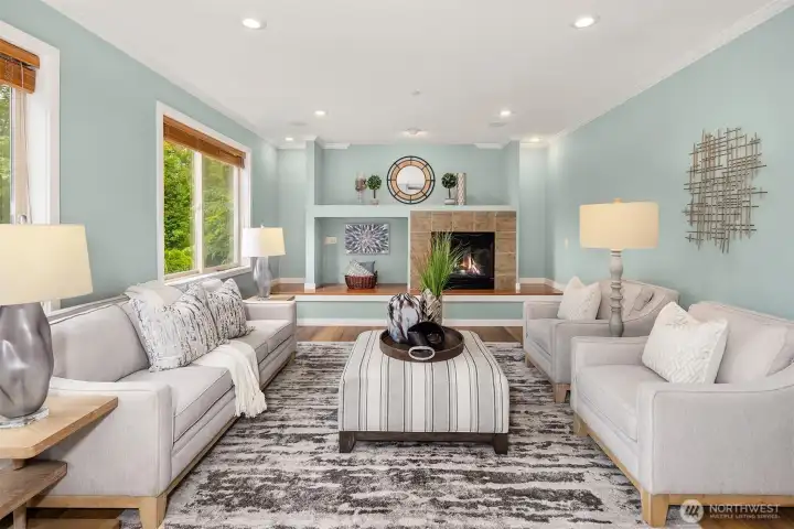 The spacious family room features a built-in gas fireplace and large windows overlooking the private backyard. The spacious family room features a built-in gas fireplace and large windows overlooking the private backyard.