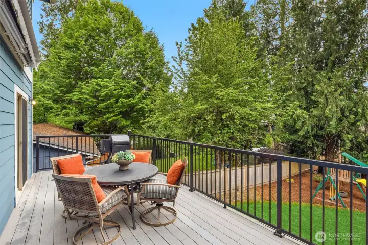 The large low-maintenance composite deck features a motorized SunSetter awning, gas stub for grilling, and beautiful backyard views. The large low-maintenance composite deck features a motorized SunSetter awning, gas stub for grilling, and beautiful backyard views.
