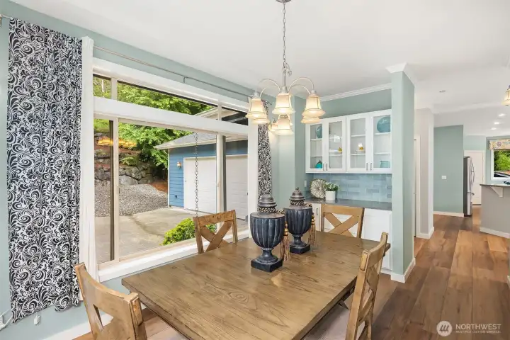 The dining room features a Butler's pantry with built-in storage and large windows with transom details that flood the space with natural light. The dining room features a Butler's pantry with built-in storage and large windows with transom details that flood the space with natural light.