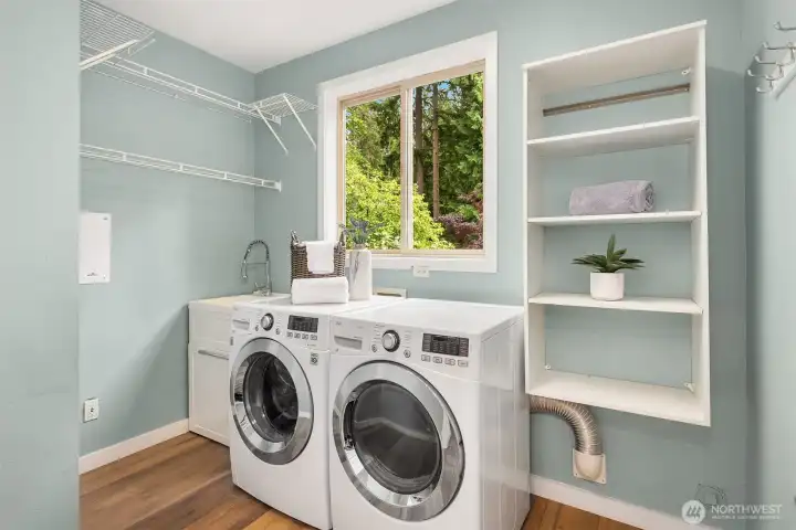 The large laundry room has a sink, shelving and hanging space. The large laundry room has a sink, shelving and hanging space.