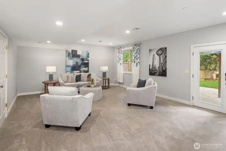 The lower level bonus room has tall ceilings, natural light, and walkout access to the patio and dreamy backyard. The lower level bonus room has tall ceilings, natural light, and walkout access to the patio and dreamy backyard.