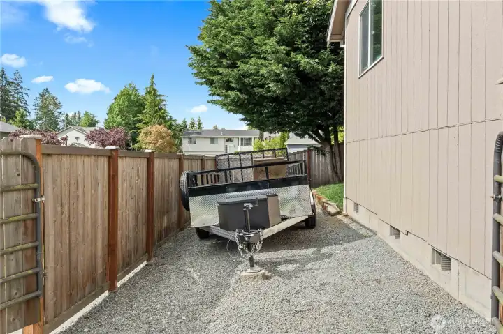 Trailer of small RV parking on side of house