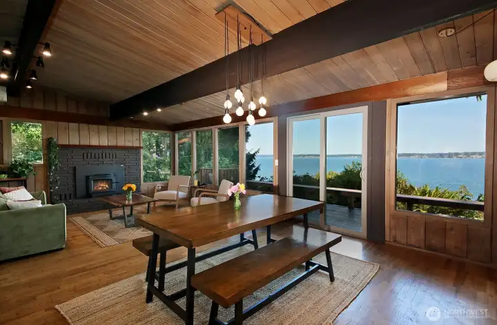 Open Living Room with Dining area (there is a separate Dining Room). Cozy wood stove provides so much warmth in the chillier seasons. Hardwood floors, wood paneling, and vintage lighting creates a warm welcoming space.