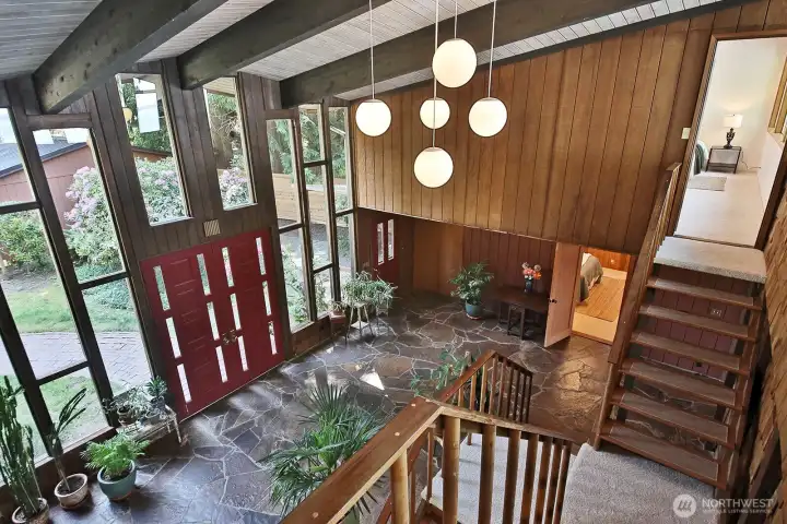 Your back is to the Primary Suite located on the east side of the home. Stairs and door to the other Primary Suite is along the right edge of photo. Lets go up those stairs and check it out.