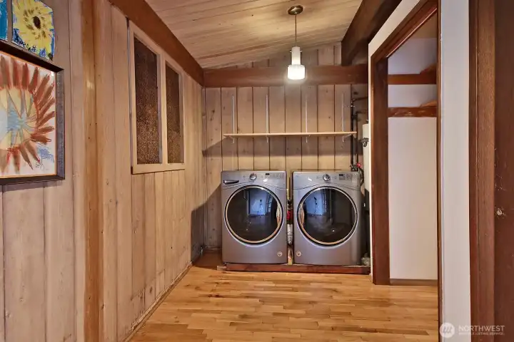 Laundry room with water heater (to the right of washer & dryer) and spacious storage space.