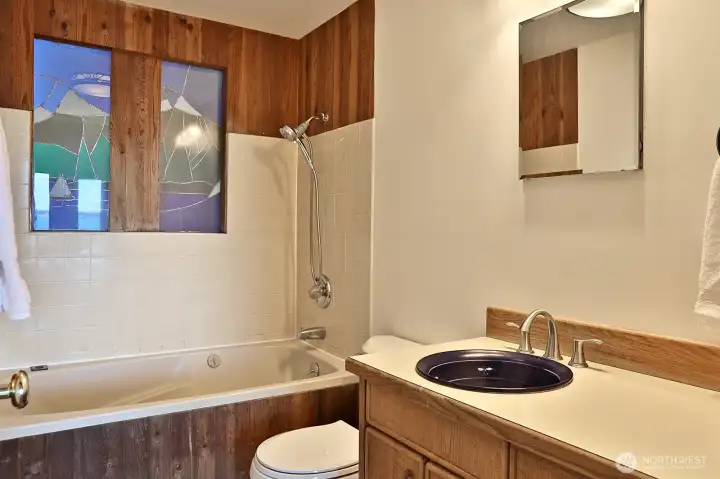 Main level full bath located off the Living Room/Dining area.