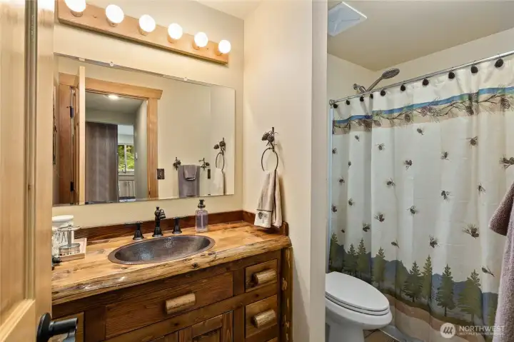 Main floor bathroom with rustic live-edge vanity & copper sink