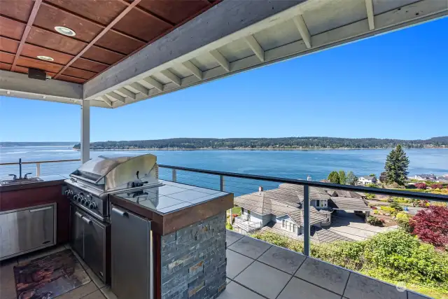 This outdoor kitchen is perfect for firing up the grill for guests while they gather round and enjoy that view. A door not far makes getting to the kitchen a snap. No trekking up and down stairs with your treats.