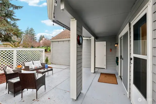 Extended partially covered patio with side garage door access