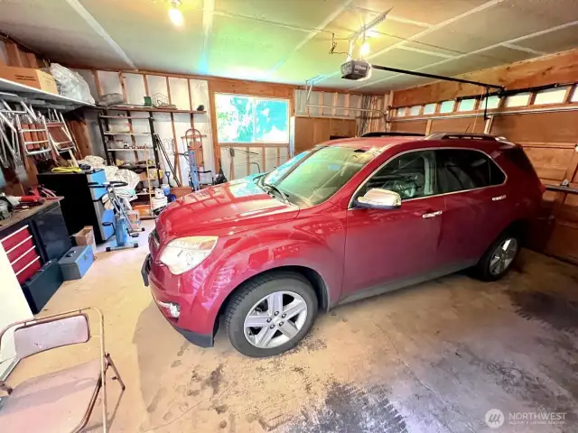 2 car garage with a side door and space for workshop