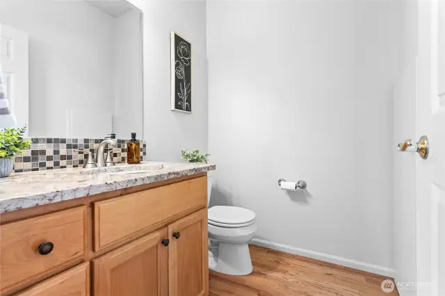 Guest bath on main floor in addition the the primary bath suite and a full bath upstairs.