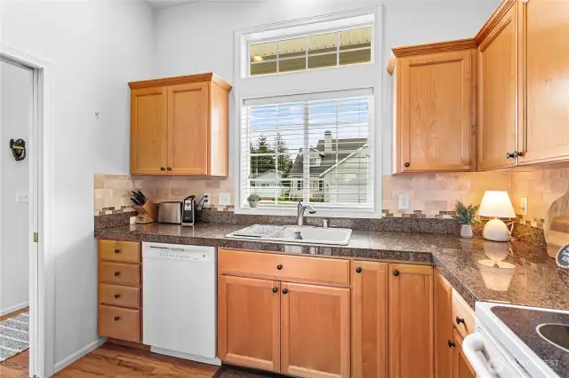 Lots of cabinets, granite counters and tile backsplash.