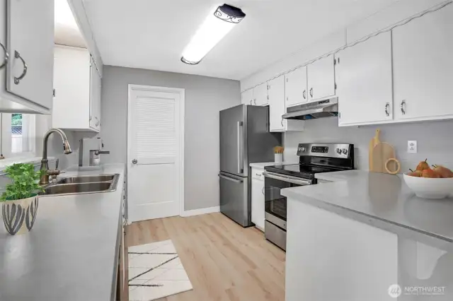 Decorative overhead lighting shines over the kitchen space.