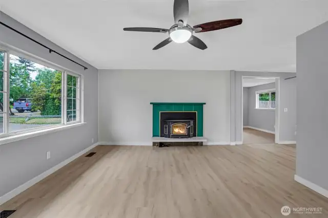 This pretty living room offers easy care flooring, cozy fireplace and stylish ceiling fan.