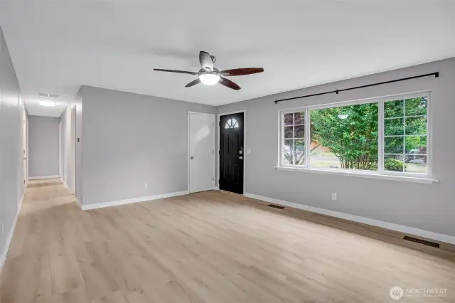 Large picture window floods the room with natural light.