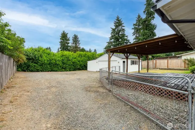 Two car detached garage sits in the back of the yard.
