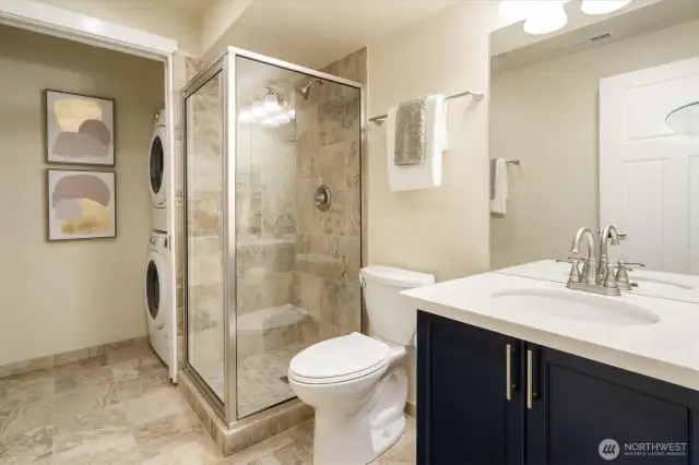 Three quarter bathroom with shower and full sized laundry in potential ADU (accessory dwelling unit) / MIL (mother in law) in basement