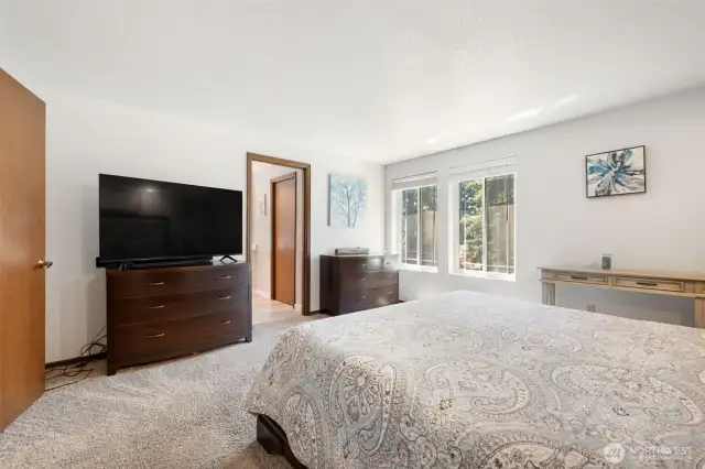 Primary bedroom with a walk in closet and an updated primary bathroom
