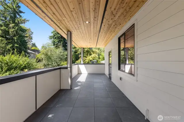 The covered deck over looks the fenced back yard with access to the kitchen
