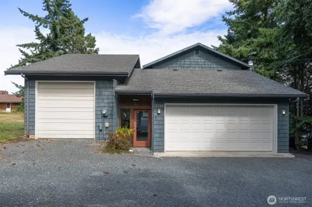 The front of the home has the enclosed entry between the attached 2-car garage and the 16 x 28 heated shop with a 12' automatic door.