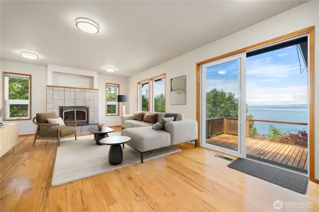 The living room has a lovely gas (propane) fireplace with incredible views and a large sliding glass door that opens onto the westerly facing deck.