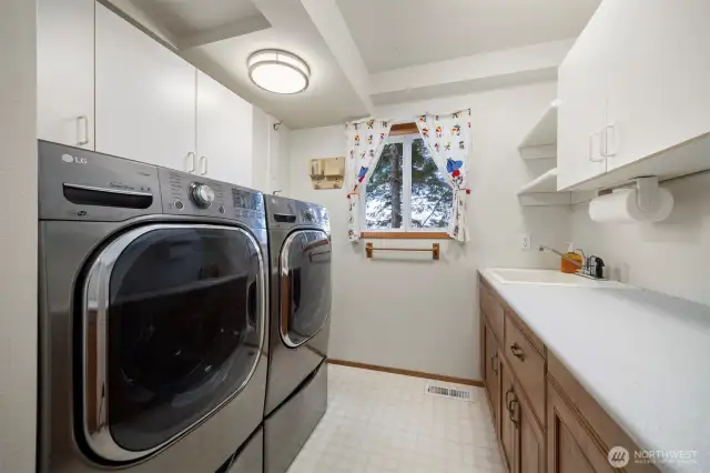 The laundry room is also on the main floor and has a lot of storage as well as a 1/2 bath.