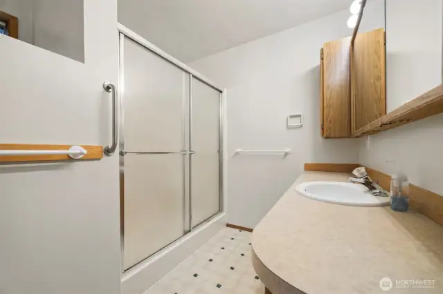 The primary bath has an oversized shower and two separate vanities.